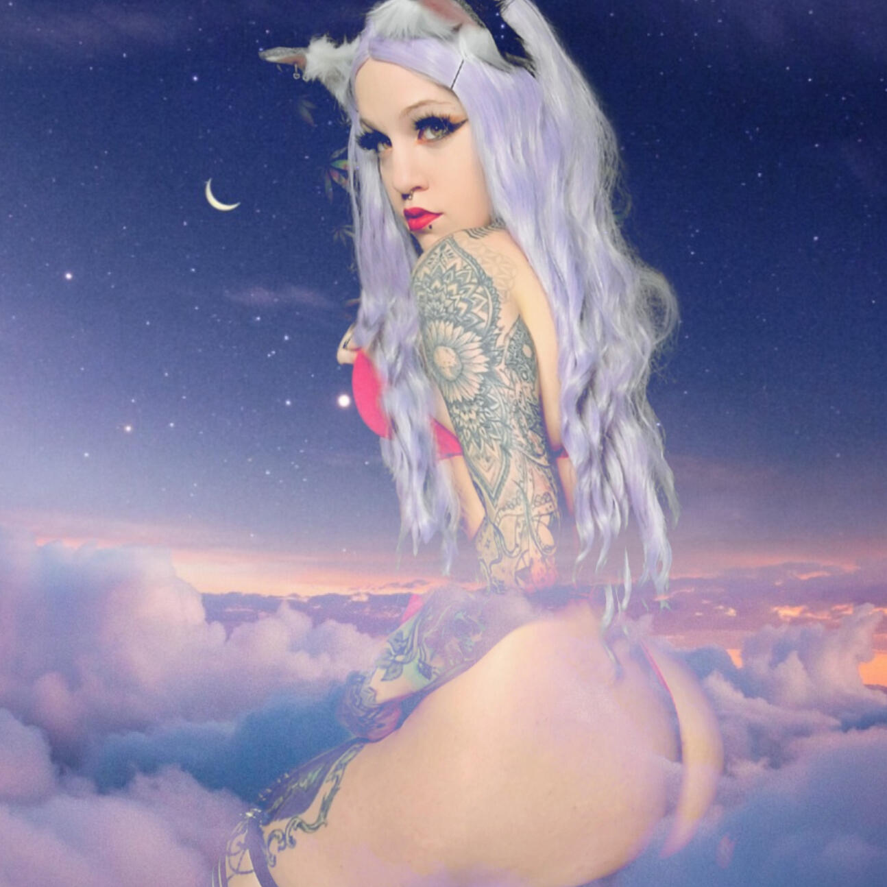 cute goth emo girl with long red hair that is half pulled up into space buns. she has beautiful mandala tattoos covering her arms and chest. girl is wearing a black dress with a short spiked collar.